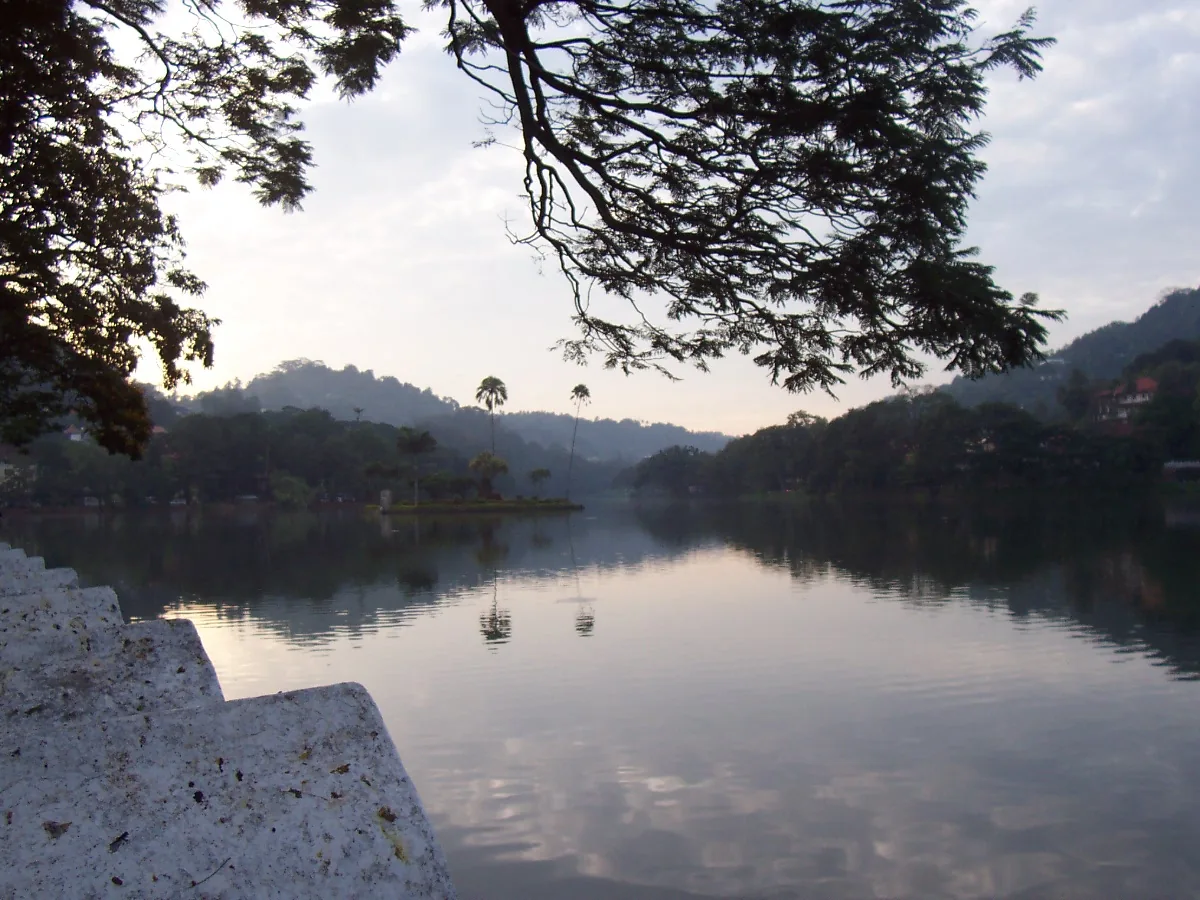 Kandy Lake in the middle of the city, hills rising behind it.