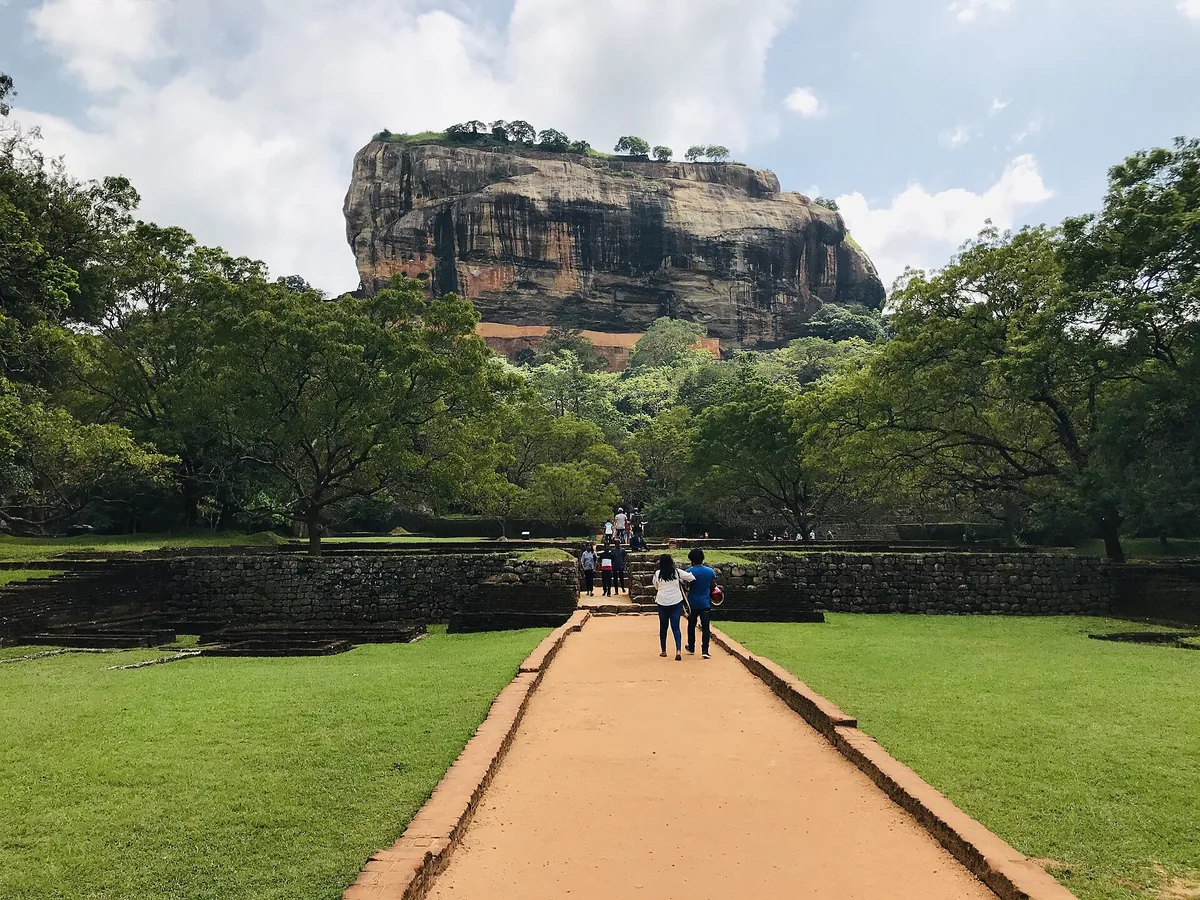The Sigiriya rock fortress rising out of flat green jungle.