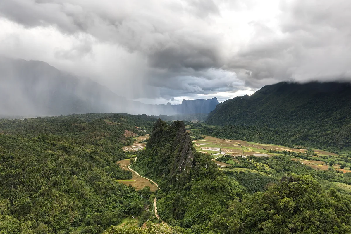 Green karst peaks above the valley at Vang Vieng, monsoon cloud coming in.