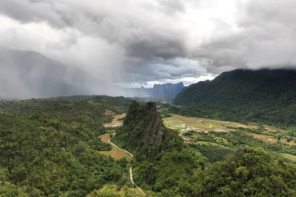 Green karst peaks above the valley at Vang Vieng, monsoon cloud coming in.
