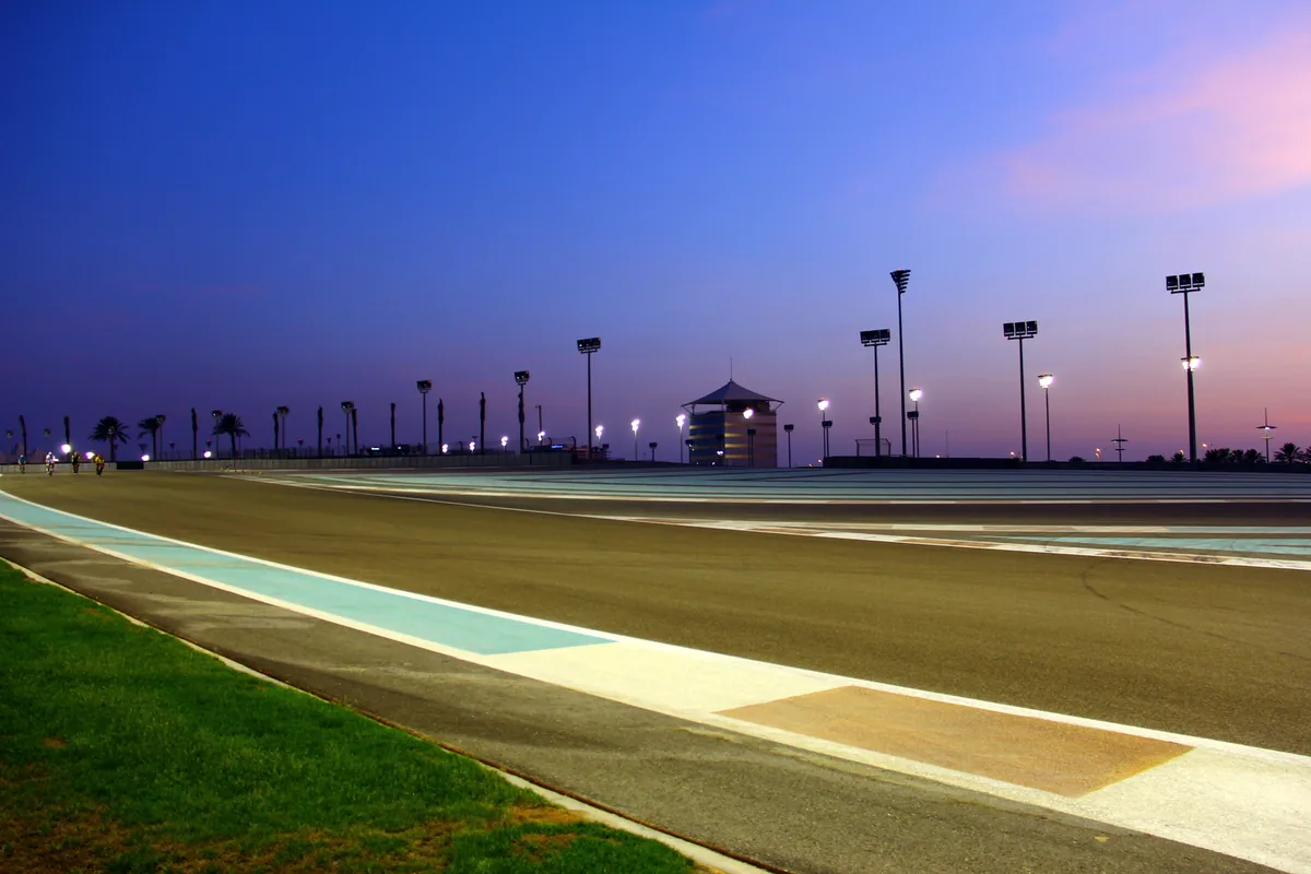 The main straight at Yas Marina Circuit, Abu Dhabi, lit at dusk.
