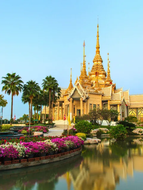 A golden Thai temple beside water